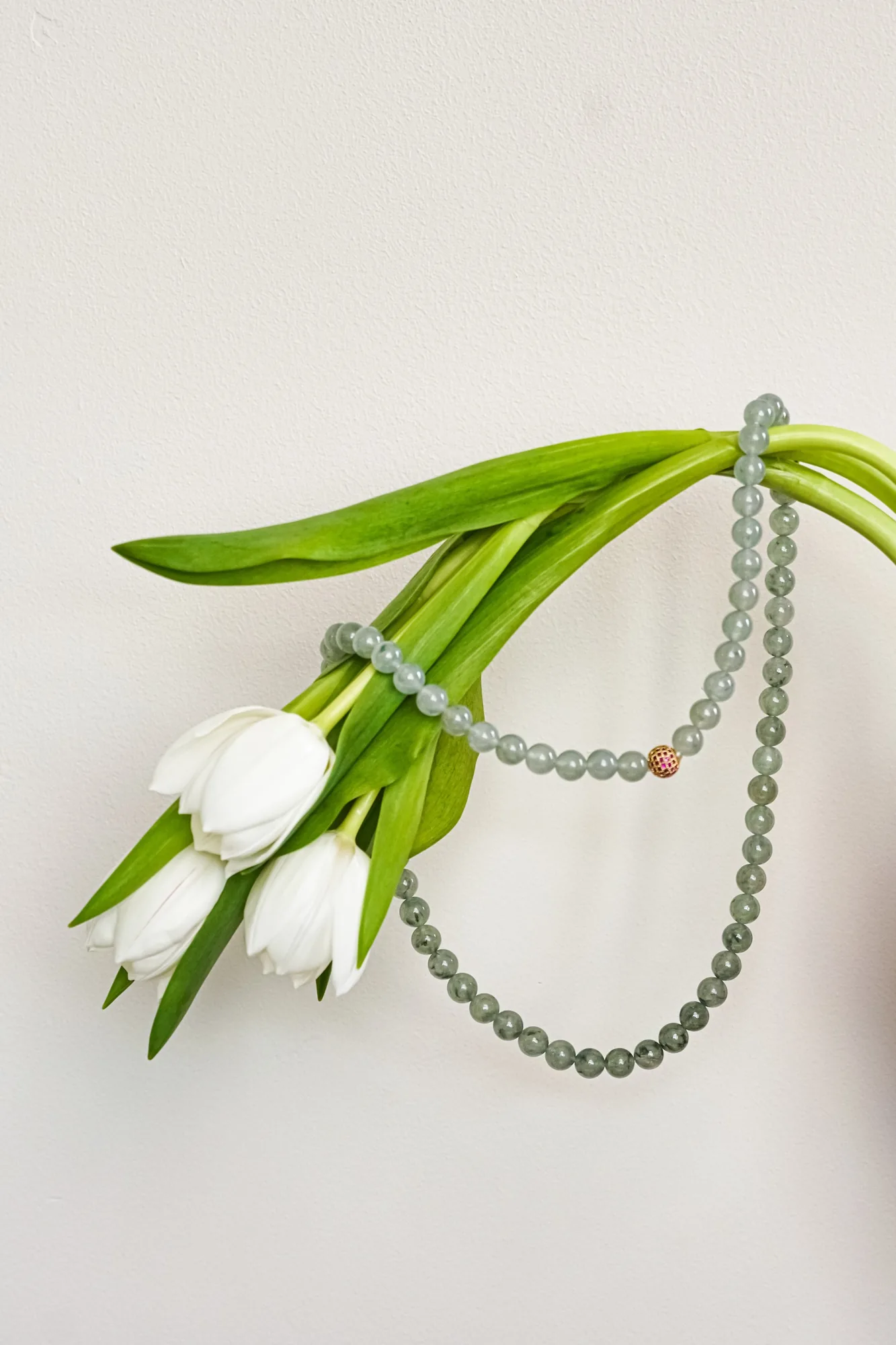 THỨC · Jade bead strand with white flowers