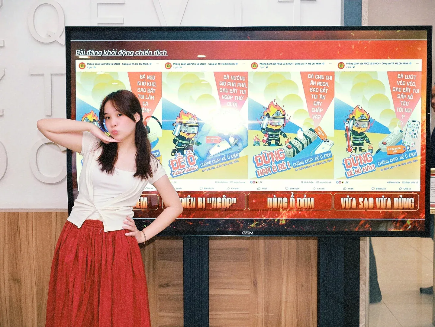 An and the campaign posters on a university exhibition screen